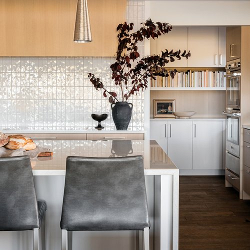 Classic kitchen makeover with white backsplash by Michigan Tile Inc