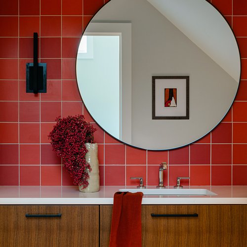 Bold bathroom design with red tile by Michigan Tile Inc